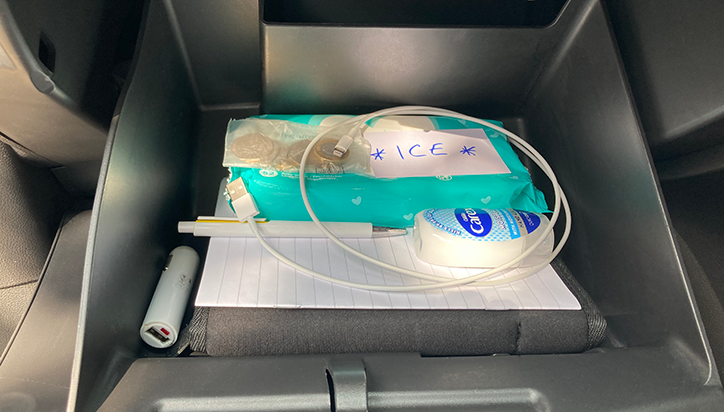 Glovebox with pen, paper, phone charger